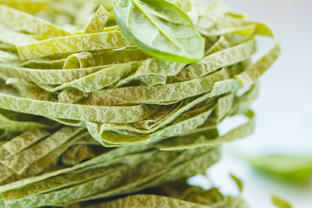 Raw green spinach pasta, macro. Vegan Healthy Food Concept.の写真素材
