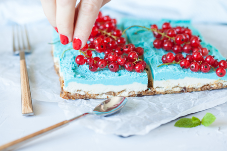 Blue raw vegan slices of cheesecake with berries. Love for a healthy vegan food concept.の写真素材