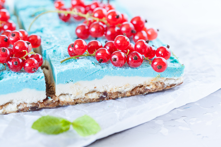 Blue raw vegan slices of cheesecake with berries. Love for a healthy vegan food concept.の写真素材