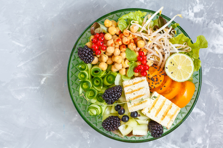 Healthy vegan lunch - buddha bowl of vegetables, chickpeas and tofu.の写真素材
