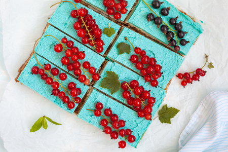 Blue raw vegan slices of cheesecake with berries. Love for a healthy vegan food concept.の写真素材