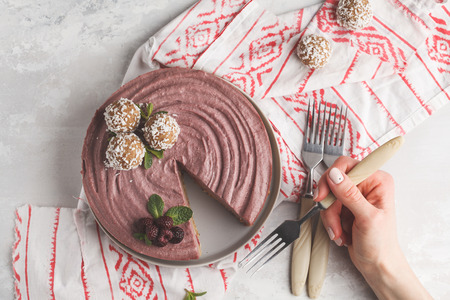 Pink berry caramel raw vegan cheesecake. Healthy vegan food concept.