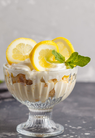 Lemon dessert, lemon trifle, cheesecake, whipped cream, parfait. Fruit mousse in glass on a light background.の写真素材