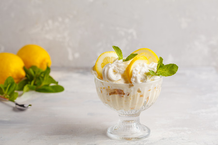 Lemon dessert, lemon trifle, cheesecake, whipped cream, parfait. Fruit mousse in glass on a light background.の写真素材