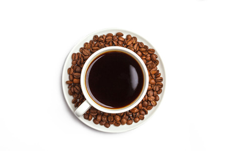 Coffee beans and coffee in a white cup isolated on white background. Top view, copy spaceの写真素材
