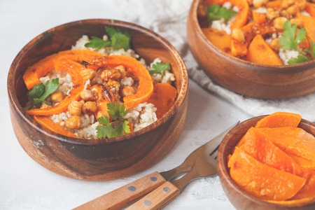Vegan healthy bowl with brown rice, baked pumpkin and chickpeas. Vegetarian food concept.の写真素材