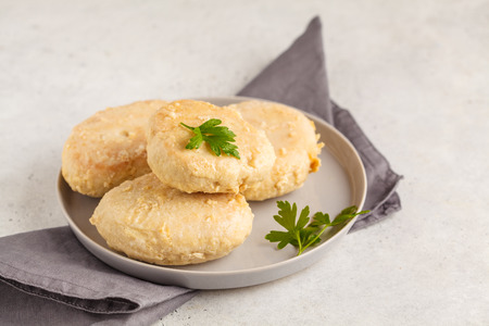 Steam chicken cutlet on a white plate, white background. Protein sports dietary food concept.