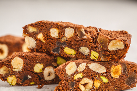 Italian dessert panforte with nuts, chocolate and candied fruits. White background, Italian dessert concept.の写真素材
