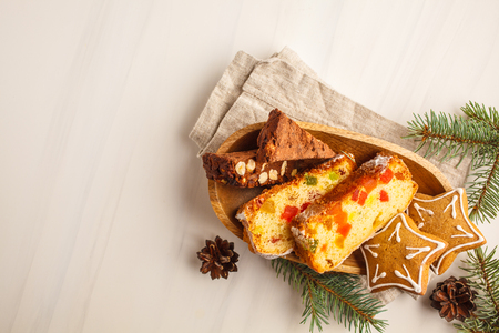 Christmas desserts of different countries (panforte, cookies and Christmas bread) wth tea on a white background, top view, copy space.の写真素材