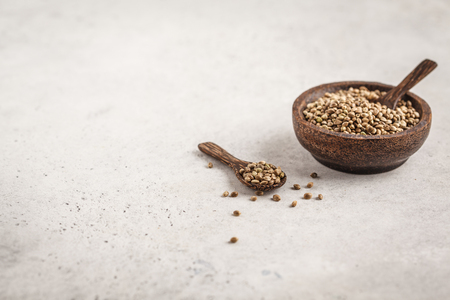 Wooden bowl of untreated hemp seeds. Superfoods concept.の写真素材
