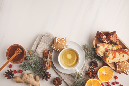 Christmas desserts of different countries (panforte, cookies and Christmas bread) wth tea on a white background, copy space, top view.の写真素材