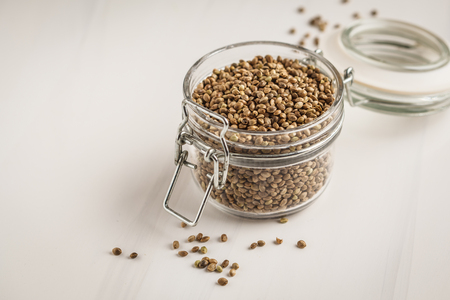 Untreated hemp seeds in glass jar. Superfoods concept.の写真素材