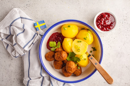Swedish traditional meatballs with broccoli, boiled potatoes and cranberry sauce. Swedish food concept.の写真素材
