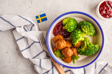 Swedish traditional meatballs with broccoli, boiled potatoes and cranberry sauce. Swedish food concept.の写真素材