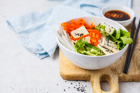 Vietnamese rice noodle with tofu and chilli vegetables salad in white bowl, top view, copy space.の写真素材