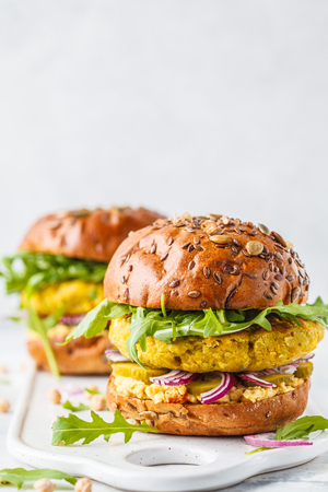 Vegan chickpeas burgers with arugula, pickled cucumbers and hummus. Plant based diet concept.の写真素材