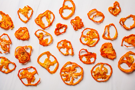 Dried tomato chips on a white background.