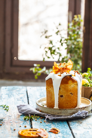 Easter cake with icing on a blue wooden table. Easter concept.の写真素材