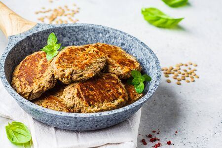Lentil cutlets in a gray frying pan. Healthy vegan food concept.の写真素材