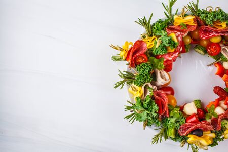 Christmas food background. Christmas wreath of holiday appetizer, white background, top view.の写真素材