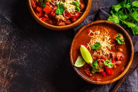 Traditional mexican bean soup with meat and cheese in a wooden bowl, top view. Mexican food concept.の写真素材