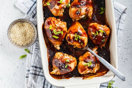 Oven-baked teriyaki chicken with green onion and sesame seeds.の写真素材