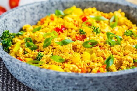 Scramble tofu with vegetables in a pan. Vegan Alternative Omelet.の写真素材