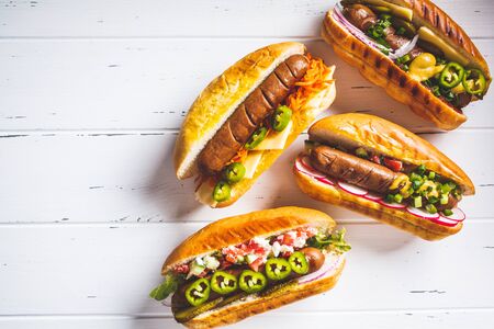Hot dogs with different toppings on a white background. Fast food concept.の写真素材