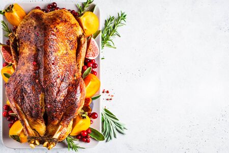 Christmas baked duck with herbs and fruits on a gray plate, copy space.の写真素材