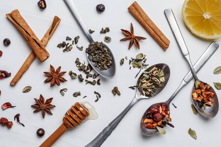 Different herbal tea with honey and spices on a white background.の写真素材