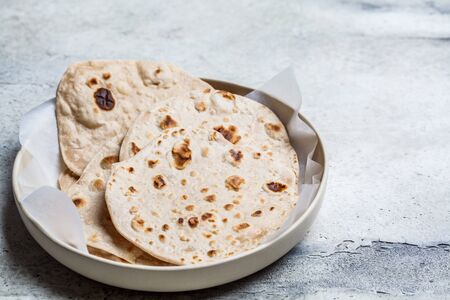 Homemade indian pita chapati on a gray background. Vegetarian cuisine concept.