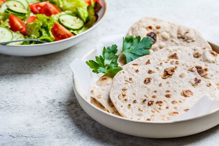 Homemade indian pita chapati on a gray background. Vegetarian cuisine concept.の写真素材