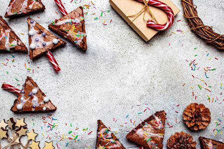 Christmas tree brownies with candy cane and icing, gray background. Christmas food concept.の写真素材