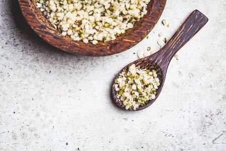 Peeled hemp seeds in a wooden bowl. Hemp - superfood, antioxidant, a healthy food supplement.の写真素材