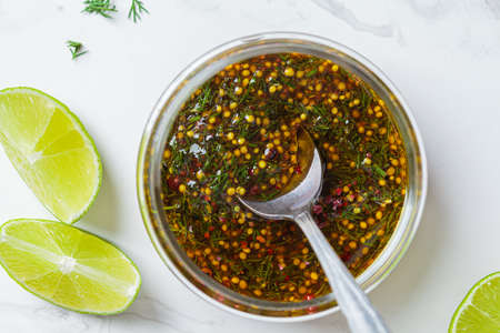 Mustard, olive oil and dill salad dressing in a glass jar, top view. Cooking healthy food concept.の写真素材