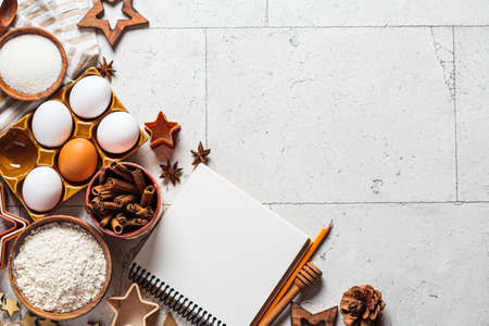 Christmas baking concept. Ingredients for christmas cookies on gray tiles background, copy space....