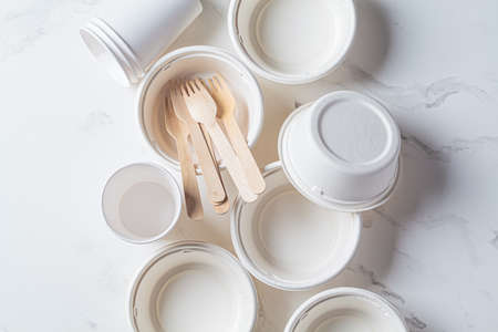 Eco-friendly recyclable tableware, zero waste concept. Paper bowls and cups on white marble background, top view.の写真素材