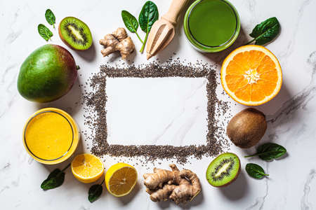 Ingredients (mango, spinach, ginger and orange) for cooking detox smoothie and frame with copy space for text.の写真素材