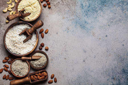 Different types of nut flour - almond, hazelnut and cashew, copy space, top view, dark background. Keto diet and gluten-free concept.の写真素材