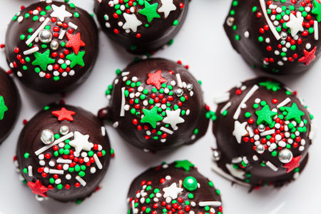Christmas handmade chocolate balls with holiday sprinkles, top view. DIY holiday gift, dessert...
