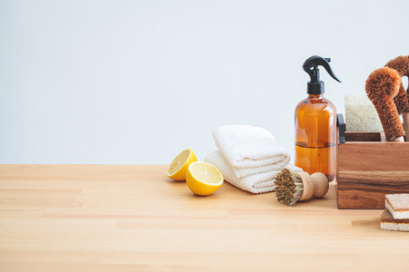 Zero waste eco friendly products and tools for kitchen cleaning, copy space. Wooden brushes, coconut sponges, spray vinegar, lemon and organic soap, gray background.の写真素材