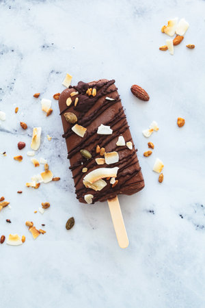 Vegan chocolate ice cream on a stick, top view. Summer dessert, plant based concept.の写真素材