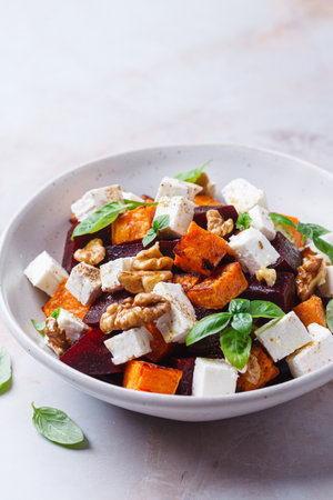 Salad with baked sweet potato, beetroot, feta and walnuts.の写真素材