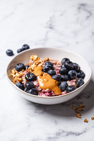 Oatmeal with blueberries and peanut butter, white background. Vegan breakfast recipe.の写真素材