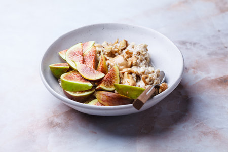 Oatmeal with figs, peanut butter, walnuts and maple syrup.の写真素材
