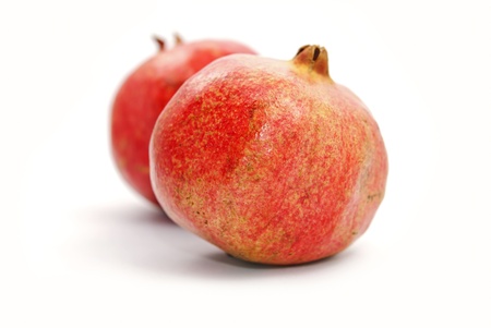 Two red  pomegranates on white backgroundの写真素材