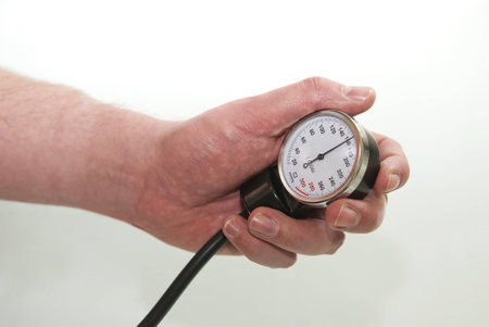 Blood pressure gage showing high blood pressure in the human hand