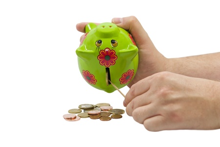 Man hands taking Euro coins from a piggy bank isolated on white backgroundの写真素材