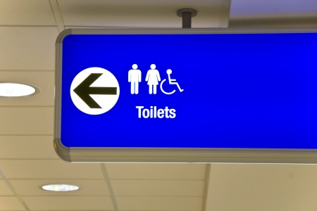 Detailed view of blue airport sign showing directions の写真素材