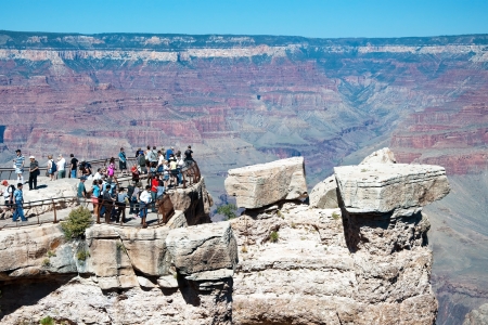 GRAND CANYON, ARIZONA - SEPTEMBER 30, 2011 - Tourist looking at south rim of Grand Canyon on September 30, 2011 in Arizona, USA. Grand Canyon is 277 miles (446 km) long, up to 18 miles (29 km) wide and attains depth of over mile.のeditorial素材